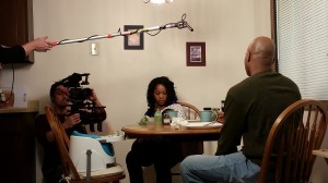 Nick Michael, Director of Photography, Joetta Wright and Jamel Anderson at the dinner table.